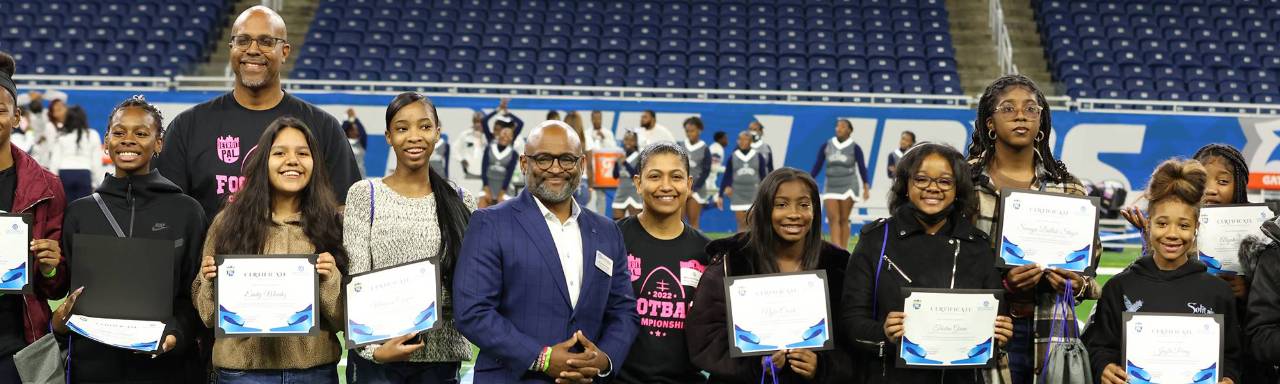 GVSU Vice President for Enrollment Development and Educational Outreach Dr Truss with students at Ford field